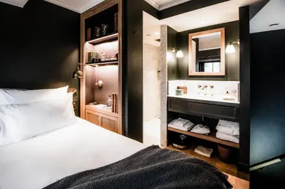 a hotel room with a bed and a sink at 1898 The Post in Ghent