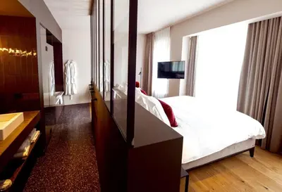 a bedroom with a bed and a dresser with a mirror at U Eat & Sleep Antwerp in Antwerp