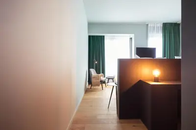 a hallway with a room with a desk and a chair at U Eat & Sleep Antwerp in Antwerp