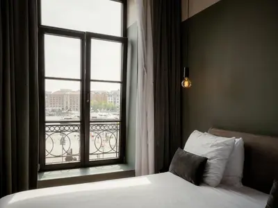 a bedroom with a bed and a large window at U Eat & Sleep Antwerp in Antwerp
