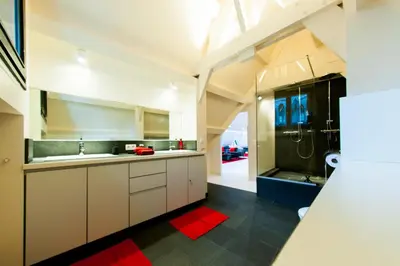 a large kitchen with a sink and a shower at Lord of Ghent in Ghent