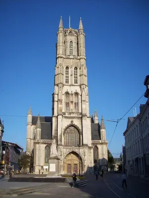an old church with a tall tower on a street at Lord of Ghent in Ghent