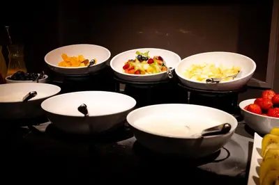 a group of bowls filled with fruit on a table at Pillows City Hotel Brussels Centre in Brussels