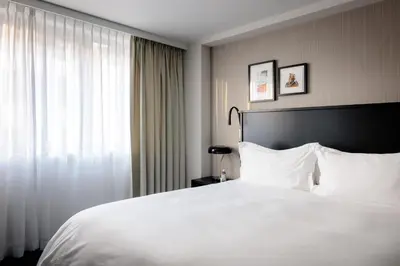 a bedroom with a large white bed and a window at Pillows City Hotel Brussels Centre in Brussels