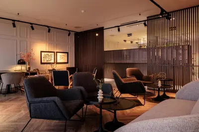 a lobby with couches and chairs and a table at Pillows City Hotel Brussels Centre in Brussels