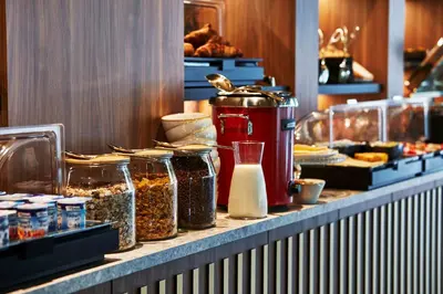 a buffet line with jars of food on a counter at The Scott Hotel Brussels in Brussels