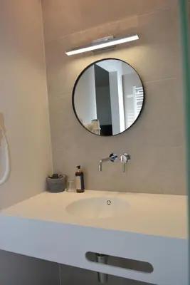 a bathroom with a sink and a mirror at Hotel B - Boskapelhoeve in Buggenhout