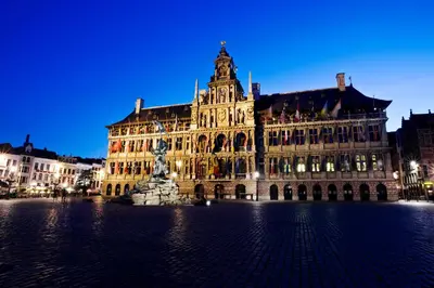 a large building with a statue in front of it at Park Inn by Radisson Antwerp City Centre in Antwerp