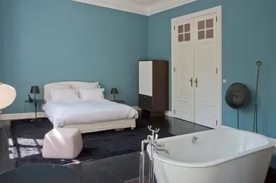 a bedroom with a bed and a bath tub at Appartement Chic in Brussels