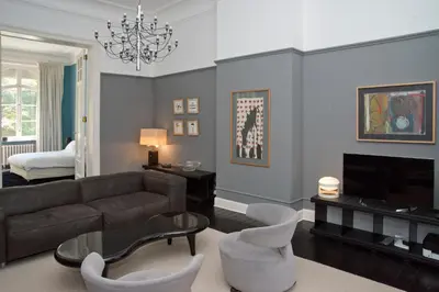 a living room with a couch and a tv at Appartement Chic in Brussels