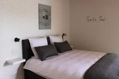 a bedroom with a large bed with two pillows at B&B 't Hoogste in Bornem