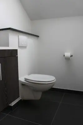 a bathroom with a white toilet in a room at B&B 't Hoogste in Bornem