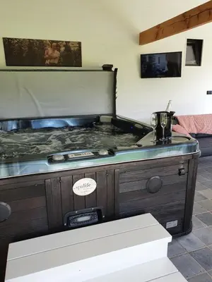 a large bed in a room with aperature at B&B 't Hoogste in Bornem
