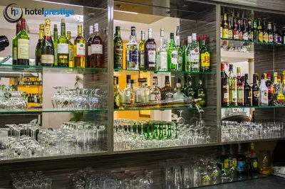 a bar filled with lots of bottles and glasses at Hotel Prestige in Brussels