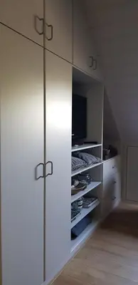a large white cabinet with a tv in a room at B&B Bergenhof in Hoogstraten