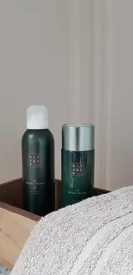 two bottles ofodorizers are sitting next to a bed at B&B Bergenhof in Hoogstraten