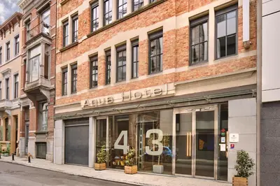 a store front of a brick building on a street at Hôtel Aqua by HappyCulture in Brussels