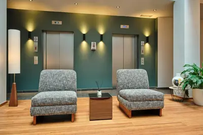 two chairs and a table in a waiting room at Hôtel Aqua by HappyCulture in Brussels