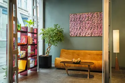 a living room with a couch and a table at Hôtel Aqua by HappyCulture in Brussels