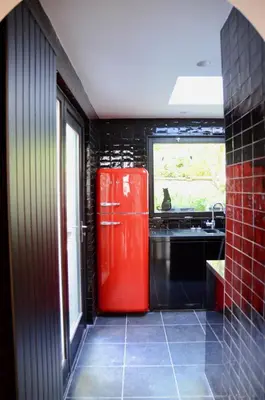 a red refrigerator in a kitchen with a window at Rock Lobster City Lodge in Antwerp