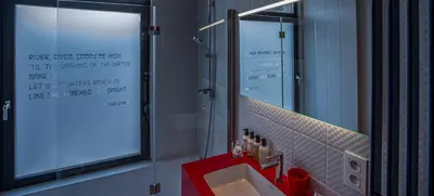 a bathroom with a sink and a mirror at Rock Lobster City Lodge in Antwerp
