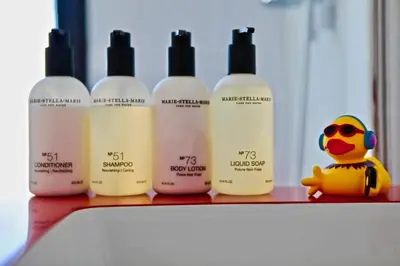 a row of bottles of sunscreen sitting on a shelf at Rock Lobster City Lodge in Antwerp