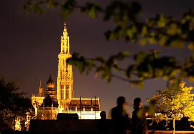 a tall building with a clock tower at night at Hotel Julien in Antwerp