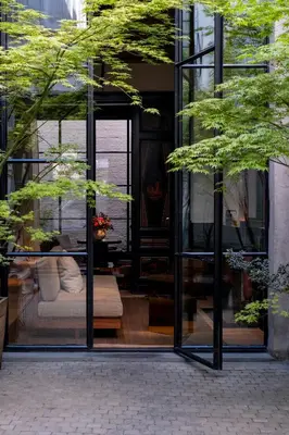 a glass building with a bed in the window at Hotel Julien in Antwerp