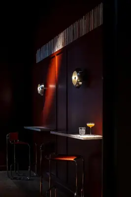 a bar with two chairs and a table with a drink at Hotel Julien in Antwerp