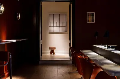 a dining room with a table and chairs and a window at Hotel Julien in Antwerp