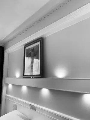 a bedroom with a shelf with a picture on the wall at Beaux ARTS in Antwerp