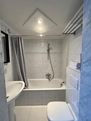 a bathroom with a tub and a toilet and a sink at Beaux ARTS in Antwerp