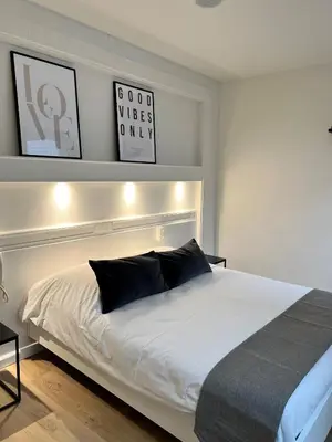 a bedroom with a large white bed with a headboard at Beaux ARTS in Antwerp