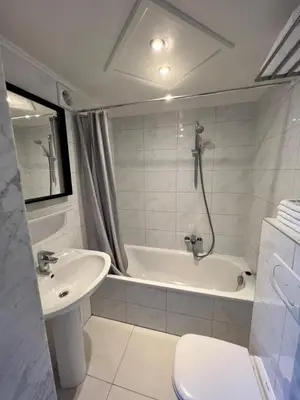 a bathroom with a sink and a tub and a toilet at Beaux ARTS in Antwerp