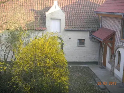 a white house with a window and a roof at Verreveld in Londerzeel