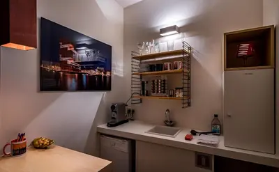 a kitchen with a counter with a sink and a refrigerator at Antwerp For Two B&B in Antwerp