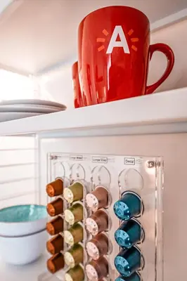 a cup sitting on top of a refrigerator at Antwerp For Two B&B in Antwerp