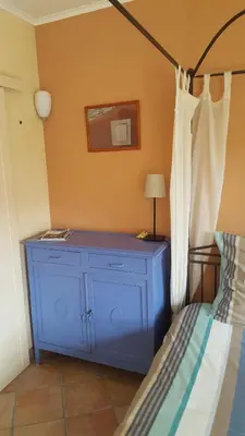 a blue dresser in a bedroom with a bed at B&B La Clé du Sud in Merelbeke