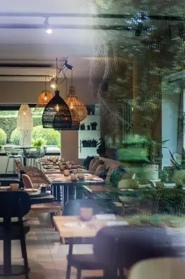 a restaurant with tables and chairs in a room at Hotel & Apartments Bibois Leuven in Oud-Heverlee