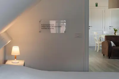 a bedroom with a bed and a table with a chair at B&B Gielse Garden in Gierle