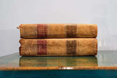 three old books sitting on top of a table at Villa Magdalena Eeklo in Eeklo