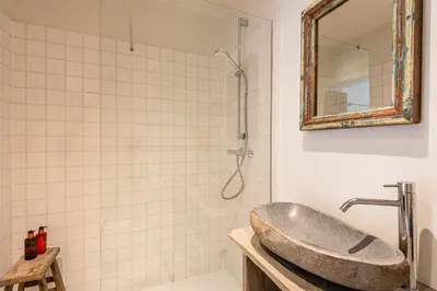 a bathroom with a sink and a shower with a mirror at Villa Magdalena Eeklo in Eeklo