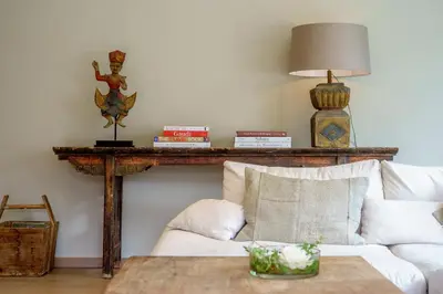 a living room with a white couch and a table at Villa Magdalena Eeklo in Eeklo