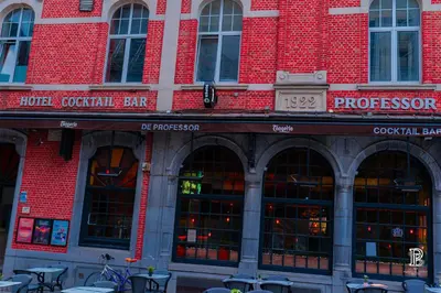 a large red brick building with tables and chairs at Hotel Professor Leuven Centrum in Leuven