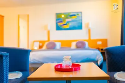 a bottle on a table in a room with a bed at Hotel Professor Leuven Centrum in Leuven