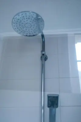 a shower with a shower head in a bathroom at Hotel Professor Leuven Centrum in Leuven