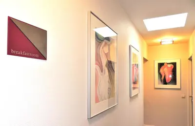 a hallway with framed pictures on the wall at Hotel Mieke Pap in Poppel