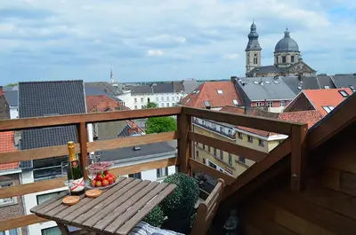 a table on a balcony with a view of a city at upstairs9000 in Ghent