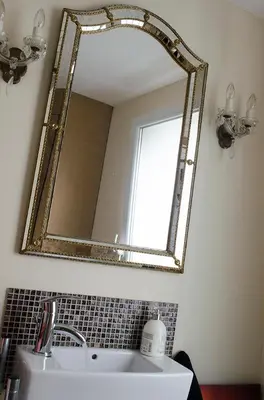 a mirror on a wall above a sink in a bathroom at upstairs9000 in Ghent