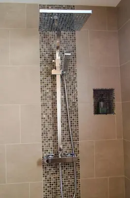 a shower in a bathroom with a tile wall at upstairs9000 in Ghent